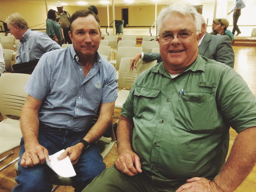 Friends Mike Whitwell and E.T. Page continued their debate after the meeting. "We always argue like this in Sunday school," Whitwell said of their 28-year friendship.