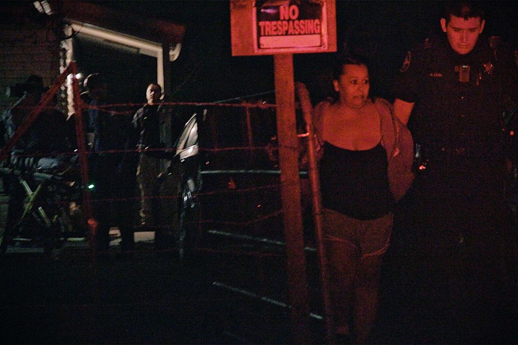 Frio County Sheriff's Deputy leads a suspect away in handcuffs.