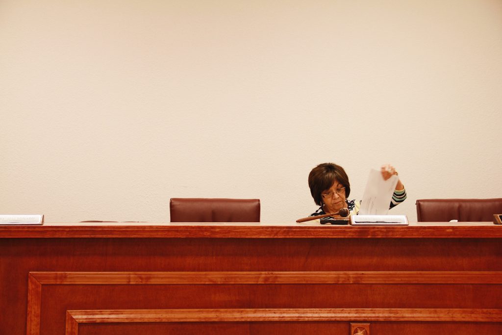 Mayor Mary Ann Obregon reads the results of the election during the city council meeting, including her own narrow victory.